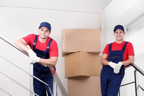 House removalists in Stjohnswood organizing boxes and furniture in a moving truck