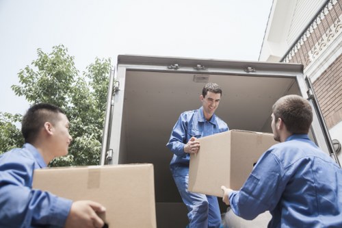 Trained staff handling boxes safely during a man and van Stjohnswood job