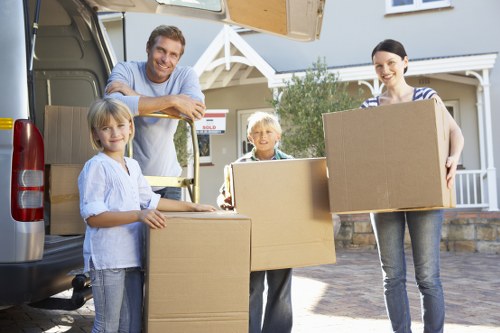 Moving team handling boxes safely during a van loading process
