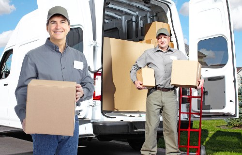 Professional movers carrying furniture in Stjohnswood